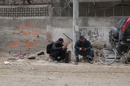 Al Ghouta, Syria - Dr. Salim (R) waits for the evacuation. (National Geographic)