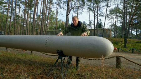 Andy  with a torpedo. (National Geographic)