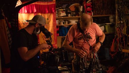 Cinematographer Nick Kraus films Conrad Anker in his gear room.   (National Geographic/Elena Gaby)