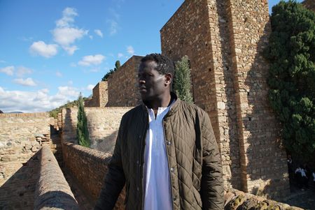 Onteka Nubio stands on the Alcazaba Fort in Malaga, looking out onto Malaga city. Alcazaba was built to defend from Moorish armies in Spain. (National Geographic/Ciaran Henry)