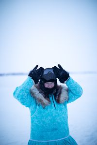 Qutan Hailstone ice fishing with her family. (BBC Studios Reality Productions, LLC/Pedro Delbrey)