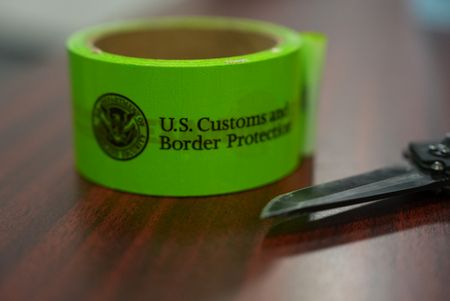 A role of electric green tape that says "U.S. Customs and Border Protection" is pictured on a table next to a knife in Rio Grande Valley,  Texas. (National Geographic)