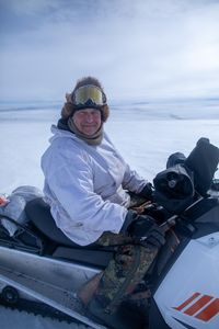 Chip Hailstone prepares his snowmobile for a journey across the tundra to hunt and observe the tundra. (BBC Studios Reality Production/Ashton Hurlburt)