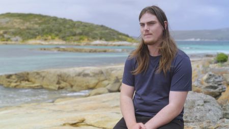 Luke Pascoe being interviewed and recalling his encounter with a shark and the injuries he sustained. (National Geographic)