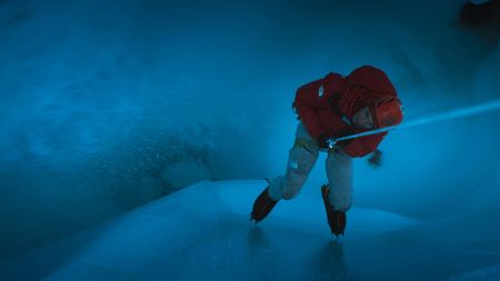 Alex Honnold descends deep into a moulin.  (photo credit: National Geographic/Pablo Durana)