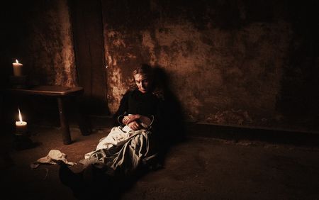 Marit waits in a prison cell, her hands locked in shackles. (Dash Productions Services LTD/Antoan Ivanov)