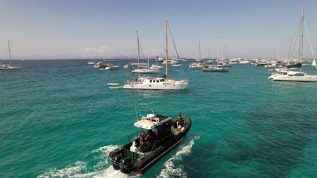 Patrol boat navigates through pleasure boats in Ibiza, Spain. (National Geographic)