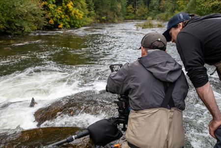 First Camera Operator Derek Frankowski and Camera Assistant Ambrose Weingart check a shot of leaping salmon. (National Geographic for Disney/Elspeth Fisher)