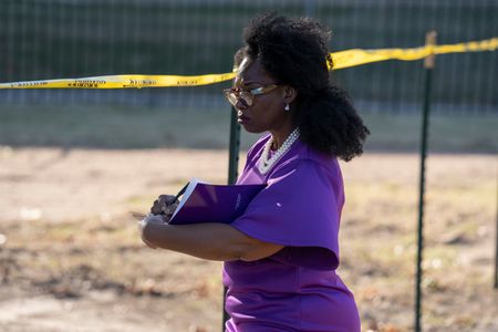 DeNeen Brown takes notes in Oaklawn Cemetery at the site where archaeologists uncovered unmarked mass graves in October 2020. The graves are thought to belong to the victims of the 1921 race massacre. (National Geographic/Christopher Creese)