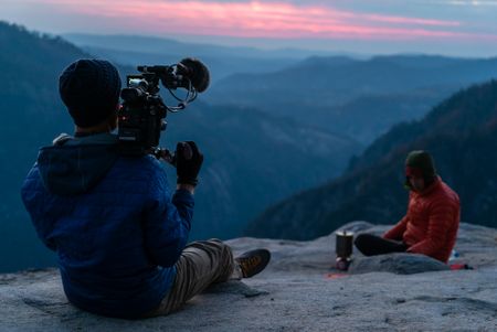 Clair Popkin our verite DP shoots a scene of Alex Honnold making dinner on his stove on top of El Cap after a day of practicing on the route. (National Geographic/Samuel Crossley)