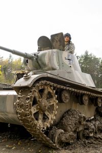 Alex Churchill with a T-26 tank. The Soviet army used thousands of t-26 tanks against Finland between 1939-'44. (National Geographic/Ciaran Henry)