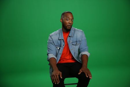 Keon Poole sitting Infront of a green screen giving a curious face. (National Geographic/Robert Toth)