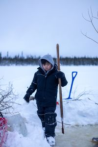 Keenan DeWilde helps his father, Ricko set beaver traps underneath the ice. (BBC Studios Reality Productions/v)