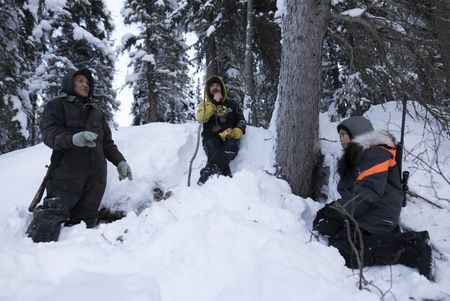Beattus Moses Jr. and Tig and Evan Strassburg look for bear dens during the winter season. (National Geographic/Pat Henderson)