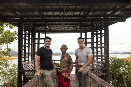 Henry Golding and Antoni Porowski pose with Peter in Batang Ai. (Credit: National Geographic/Annice Lyn)