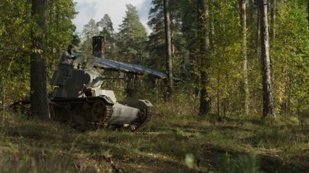 Man on a tank in the woods. (National Geographic)