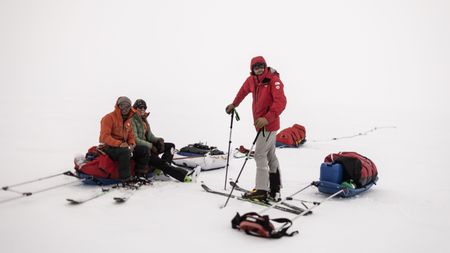 (Left to right): Adam Mike Kjeldsen, Dr. Heidi Sevestre and Alex Honnold take a break from skiing across the Renland Icecap in Eastern Greenland.  (photo credit: National Geographic/Pablo Durana)