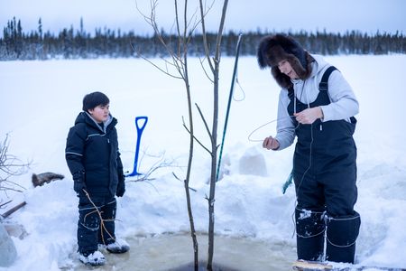 Ricko DeWilde teaches his son Keenan DeWilde how to properly set a beaver trap under the ice. (BBC Studios Reality Productions/v)