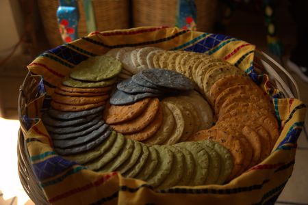 Fresh, handmade tortillas are displayed at El Comalote Restaurant in Antigua, Guatemala. The colors are created by the rich array of heritage grains used here to make tortillas and other corn-based foods. El Comalote founder Gaby Perdomo's mission is to ensure the survival of locally produced corn by putting it on the menu at restaurants around the country. (National Geographic/Adnelly Marichal)