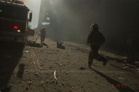 Firefighters run through thick smoke towards the Alfred P. Murrah Federal Building, following the bombing on April 19th, 1995, in Oklahoma City, Okla. (Danny Atchley)