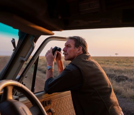 Driver Pete Blackwell gazes across the plains of Maasai Mara, Kenya. (National Geographic for Disney/David Chancellor)