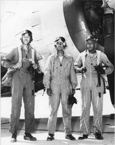 Henry Thaddeus Stewart and James Harvey (second and third, from L to R) stand next to a military plane. (James Harvey)