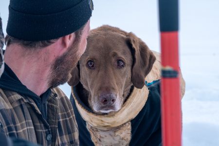 Johnny Rolfe and his dog Java collect ice glacial water. (BBC Studios Reality Production/Patrick Henderson)