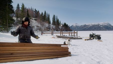 Joel Jacko builds a dock during the winter season. (National Geographic)