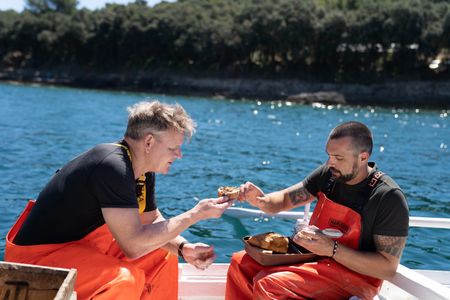 Croatia - Croatian Chef, David Skoko (R), servers Gordon Ramsay conger eel pâté. (Credit: National Geographic/Justin Mandel)