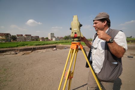 Hussien Mossah, one of the workers at the Pi Ramesses dig site in Egypt, takes measurements. (Windfall Films)