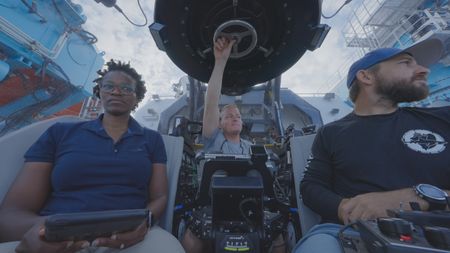 Zoleka Filander and Matt Smukall get ready to head down in one of the OceanXplorers submersibles to explore one of the recently discovered pinnacles surrounding the island of Bimini, in the hopes of findings signs of migrating great hammerheads. (National Geographic)