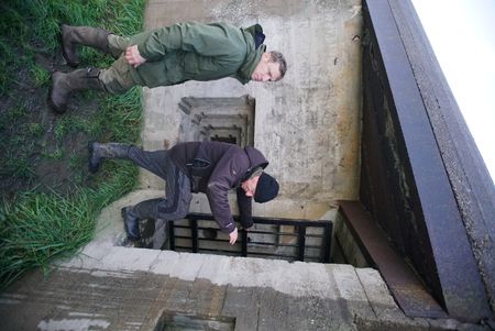 Andy Torbert entering a German bunker on Walcheren Island with Bunker Foundation volunteer Marc Machielse. (National Geographic/Ciaran Henry)