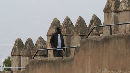 Onyeka Nubia walks along the defensive walls of the Gibralfaro in M·laga, Spain. (National Geographic)