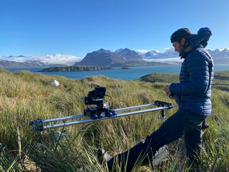 Camera Operator Sam Meyrick films an  albatross on the nest. (National Geographic for Disney/Imogen Prince)