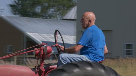 Dr. Pol driving a red tractor at the Pol family's farm. (National Geographic)