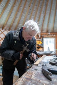 Andy Bassich creates a snow saw that will help him build a snow shelter for himself and his partner, Denise. (BBC Studios Reality Productions/Ben Mullin)