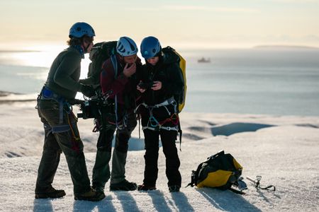 Cameraman Jamie Holland films Andreas Alexander and Melissa Marquez operating a drone on a Svalbard glacier.  (National Geographic/Mario Tadinac)