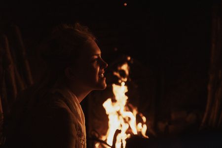 Mary Dunbar smiles, seated beside a fire. (Dash Productions Services LTD/Antoan Ivanov)