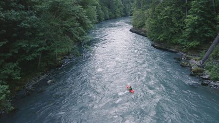 Chris Korbulic kayaking down a river.  (photo credit: National Geographic/Pablo Durana)