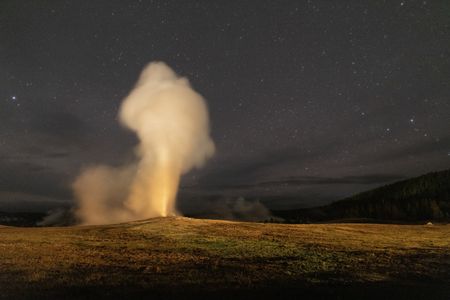 Old Faithful erupting at night. (National Geographic/Jake Hewitt)