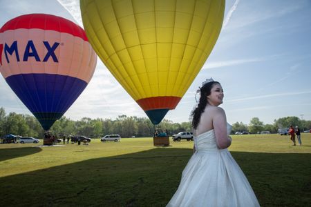 Toni Phillips waits for her fiancé David Wells Jr., at the "Elope at the Eclipse" event in Russellville, Arkansas, on April 8, 2024. Over 350 couples traveled to Russellville, Arkansas, to elope under the total solar eclipse. (Credit: Aaron Huey)