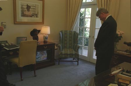 President Bill Clinton stands in the outer Oval Office of The White House as he watches Robin Marsh reporting live from the site of the Oklahoma City Bombing, on April 19th, 1995, in Washington, D.C. (Sharon Farmer/William J. Clinton Presidential Library)