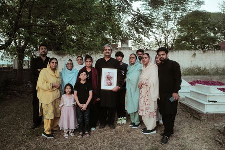 Amir Waseem holds a portrait of Chaudry Wali Mohammad surrounded by his family in Rawalpindi, Pakistan. Corporal Chaudry Wali Mohammed was a member of Force K6, an Indian Regiment of mule handlers in WW2. Amidst the chaos of Dunkirk and the advancing German Army, one little-known Indian Regiment fights for victory and independence. (National Geographic/Daniel Dewsbury)