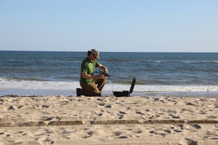 Tim Regan setting up his drone on the beach. (National Geographic/Mariana Kneppers)
