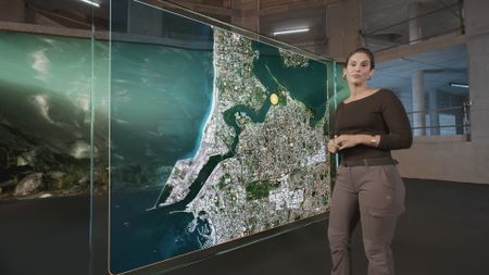 Dr. Diva Amon pointing at a GFX map while in the shark studio lab. (National Geographic)
