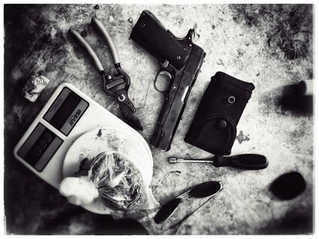 A table with drugs, scale, wire cutters and guns. (Nick Quested)