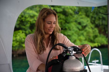 Dr. Alex Schnell prepares her SCUBA gear on board a dive vessel in the Lembeh Strait.  (National Geographic for Disney/Craig Parry)