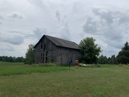 Ben Reinhold and Charles Pol walk up to inspect the old barn they need to take down. (National Geographic)