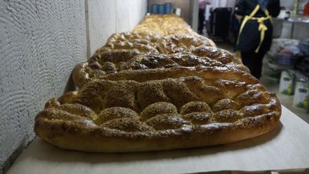 Freshly baked Ramadan Pide is displayed at Master Baker Sami Eryılmaz's bakery, Tophane Tarihi Tas Firin, in Istanbul. Eryılmaz's and other Turkish bakers make this bread one month a year, to celebrate the Muslim holiday of Ramadan.  (National Geographic/Madeline Turrini)