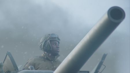 Staff Sergeant Johnnie Stevens (played by Juwon Adedokun) looks out of the tank, surrounded by snow during the treacherous journey to Tillet, in a historic reenactment produced for "Erased: WW2's Heroes of Color." Staff Sergeant Stevens was a tank commander with the 761st Black Panther Tank Battalion who served in WW2. (National Geographic)